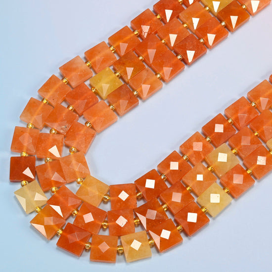 Natural red aventurine faceted flat square beads in several strands curved into a wide U, orange-red and peach orange stone
