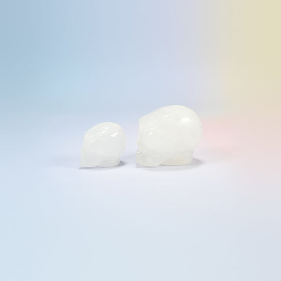 Two clear quartz alien head crystal carvings, 1.5 inch and 2 inch, milky clear natural stone