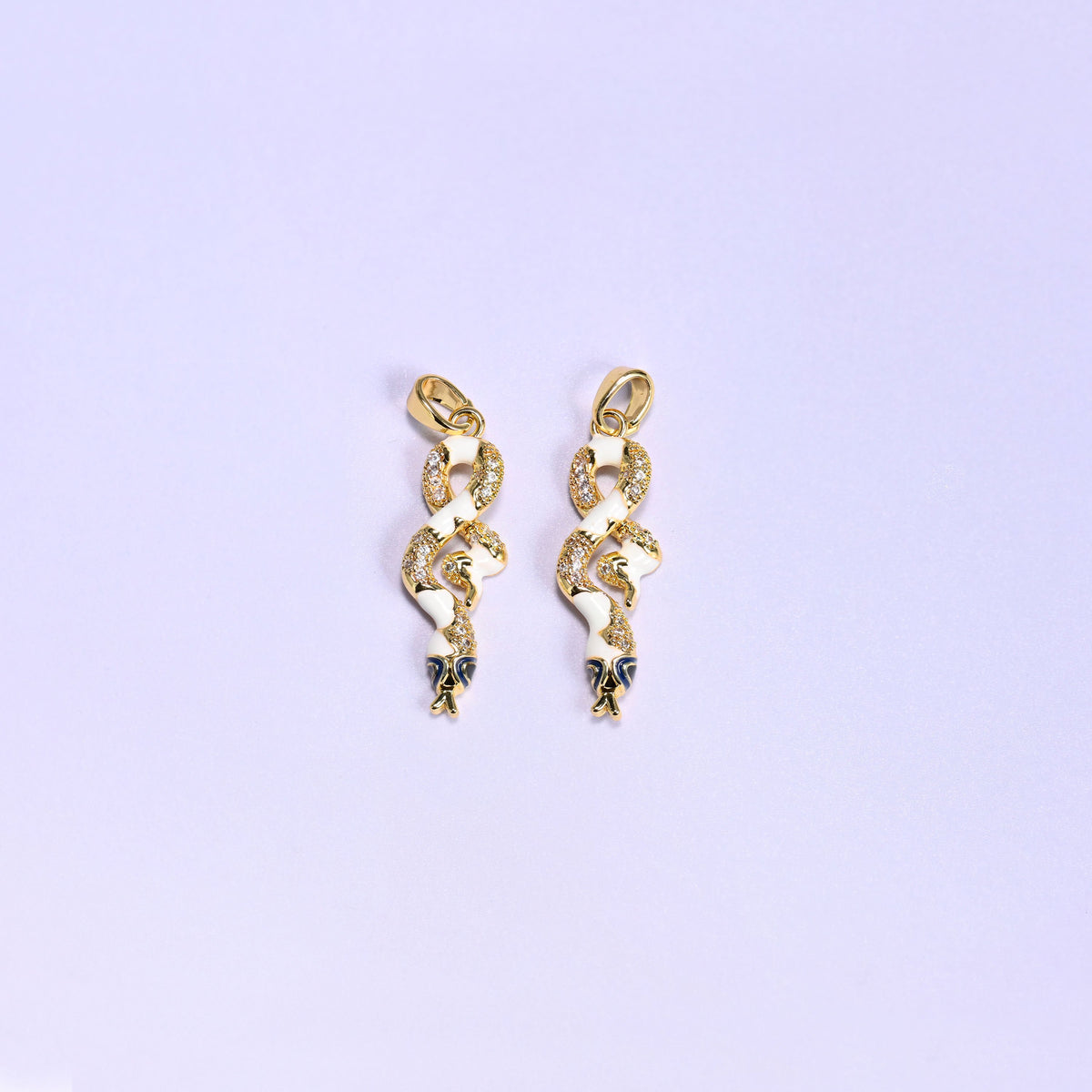 Enamel Snake Zirconia Charms in white, two 18K gold plated coiled snake pendants with white enamel bodies, clear zirconia pave and navy enamel heads.