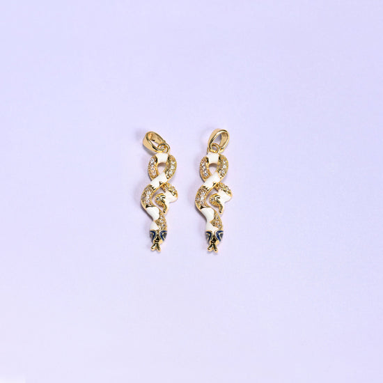 Enamel Snake Zirconia Charms in white, two 18K gold plated coiled snake pendants with white enamel bodies, clear zirconia pave and navy enamel heads.