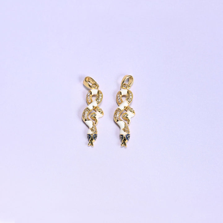 Enamel Snake Zirconia Charms in white, two 18K gold plated coiled snake pendants with white enamel bodies, clear zirconia pave and navy enamel heads.