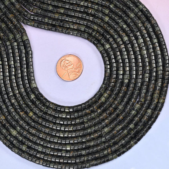 Natural Kambaba Jasper smooth heishi disc beads in deep forest green to black with distinctive circular orbicular patterns, finished with a polished, sophisticated look.