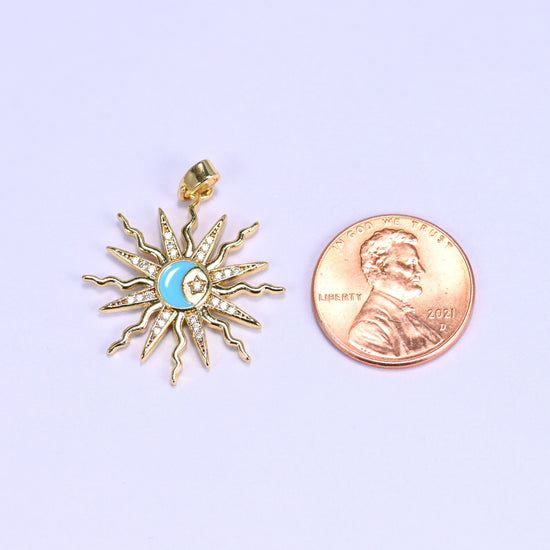 Enamel moon sun zirconia charm scale shot, the blue enamel sunburst pendant photographed next to a US penny.
