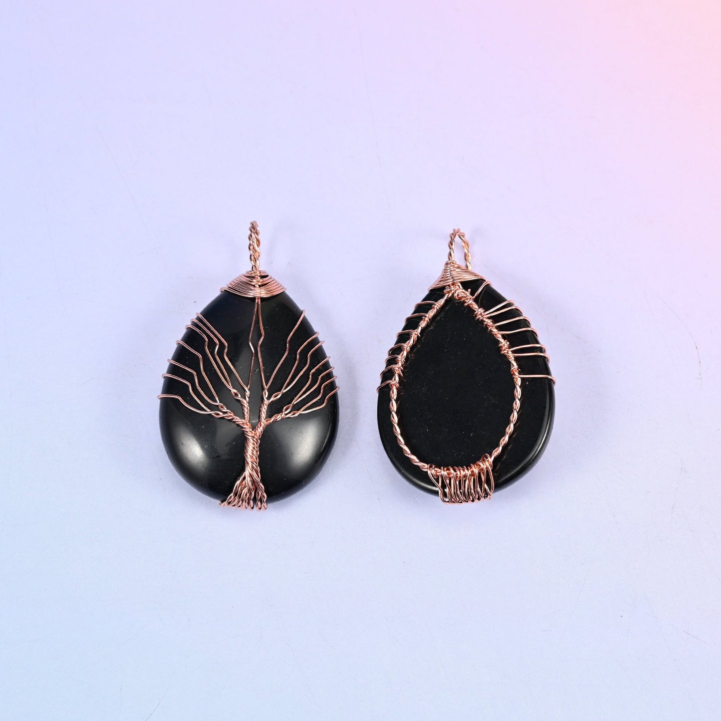 Teardrop Crystal Pendant with Copper Wired Tree in black obsidian, front view beside the reverse so the bail and wire cage construction are clear.