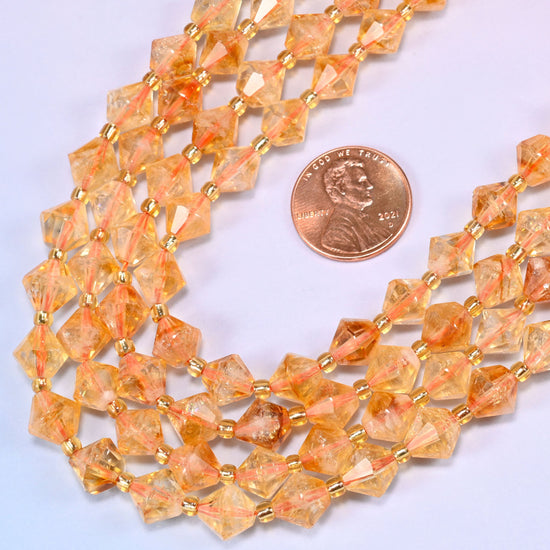 Citrine bicone beads in a wide curve, 8mm beads with a gold-tone spacer between each one.