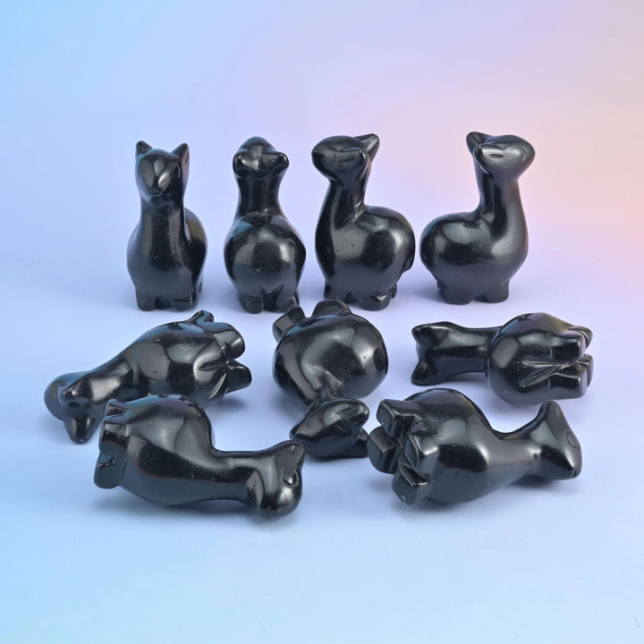 2 inch alpaca crystal carving with a long neck, tipped ears and tucked legs, polished to a high shine