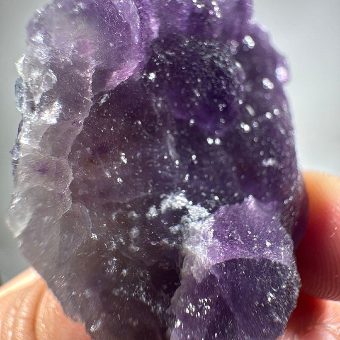 Macro of the crystalline face, sugary texture catching light in fine points