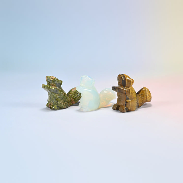 Three 2 inch long tail squirrel crystal carvings in natural unakite, opalite and natural tiger eye