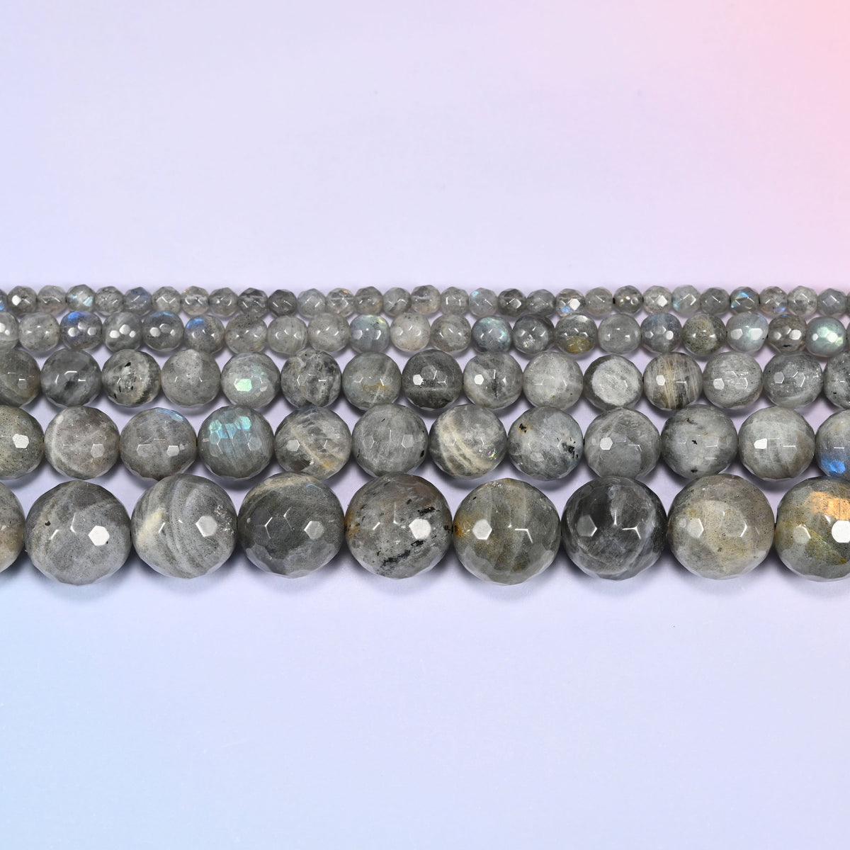 Gray Labradorite faceted round beads in three horizontal rows, the bead sizes stepping from small to large