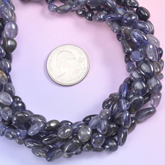 Inky blue-violet nuggets that read almost black in shadow and open to soft periwinkle when the light moves