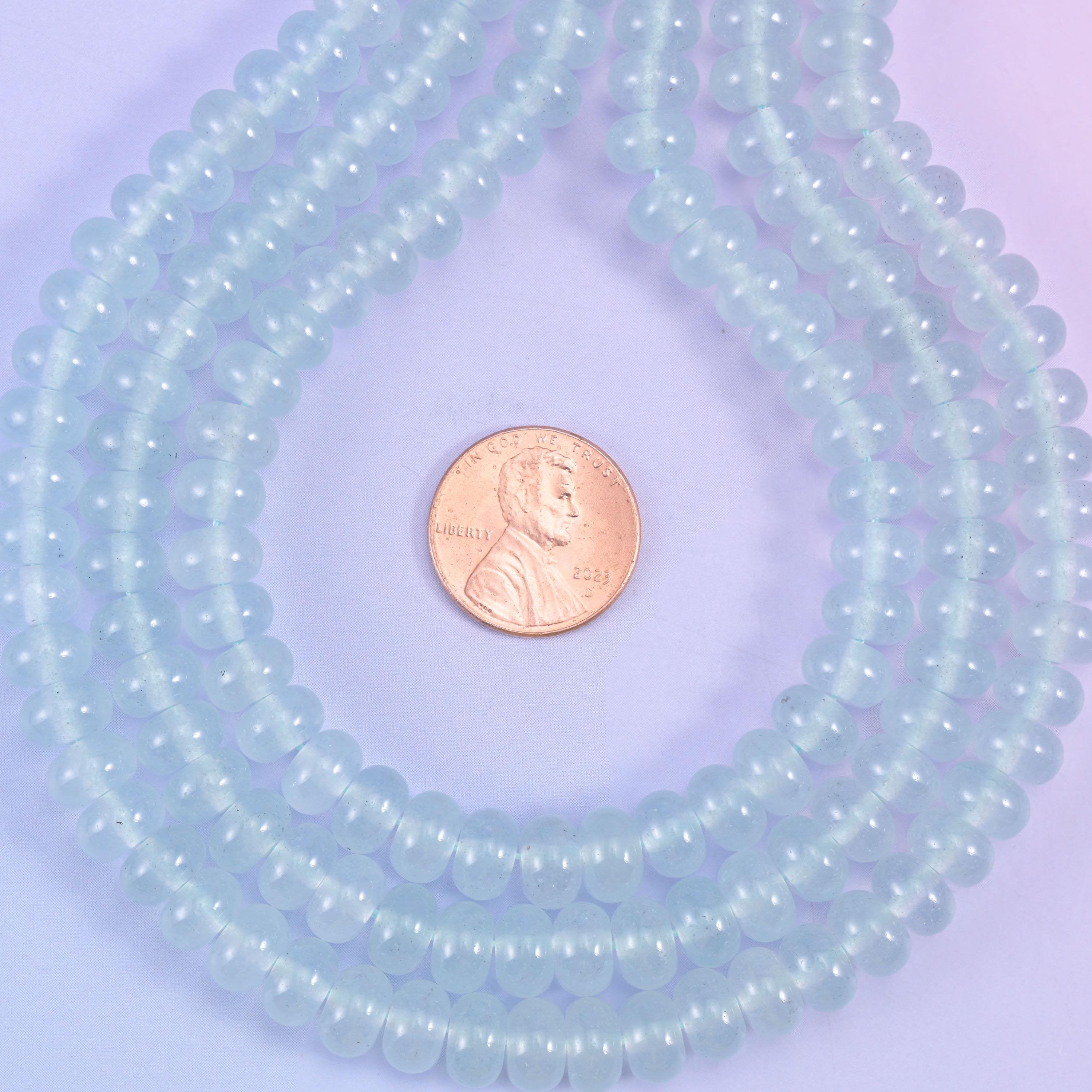A soft, icy pastel blue under a clean gloss, cut as a slim rondelle — the powdery kind of blue that keeps a design light rather than loud.