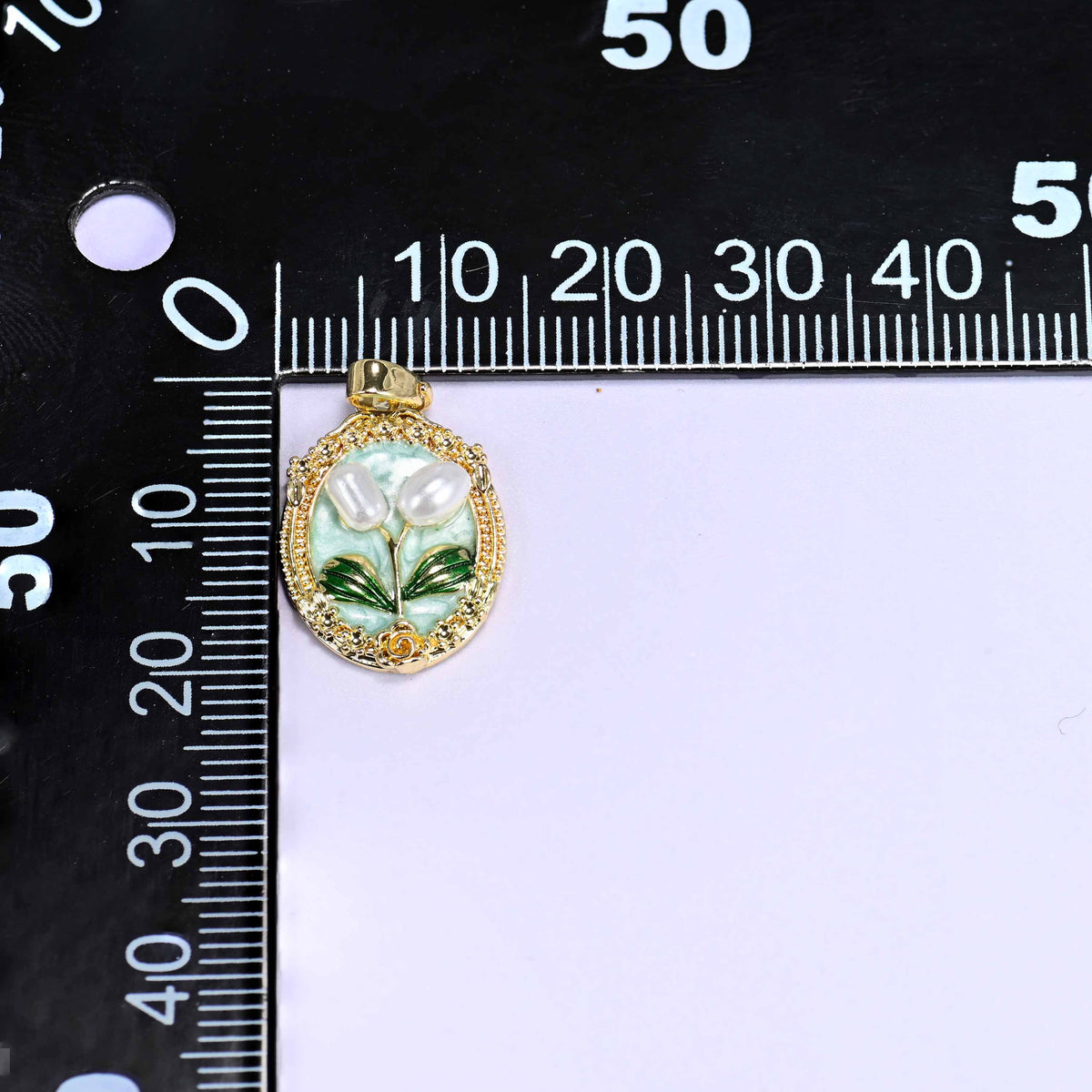 Enamel Oval Tulip Flower Pendants on a millimetre ruler, a single mint pendant shown front-on against the scale.