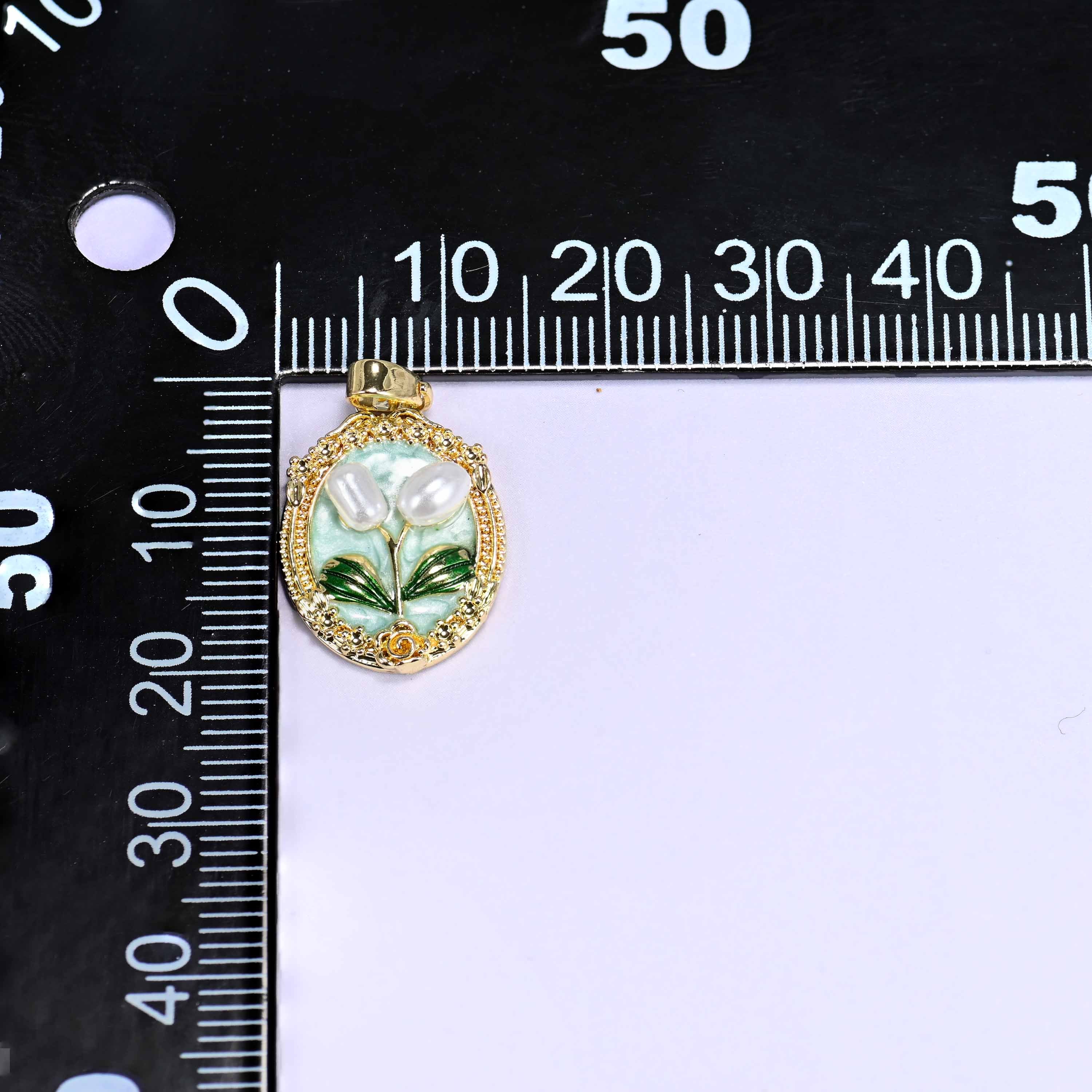 Enamel Oval Tulip Flower Pendants on a millimetre ruler, a single mint pendant shown front-on against the scale.