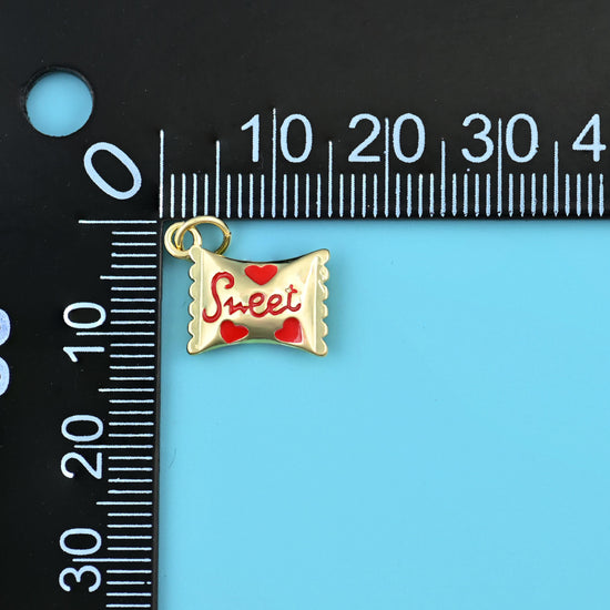 16mm enamel sweet candy charm on a millimetre ruler, red script and hearts on polished gold.