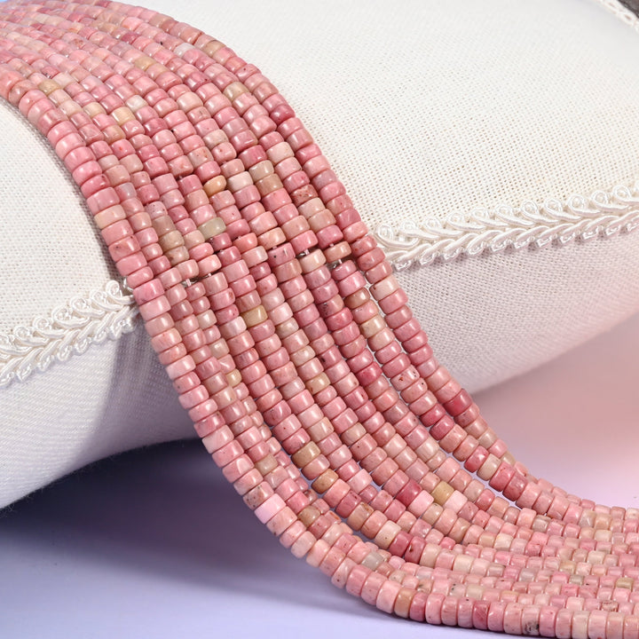 Natural Pink Rhodonite smooth heishi disc beads in soft blush to rosy pink tones.