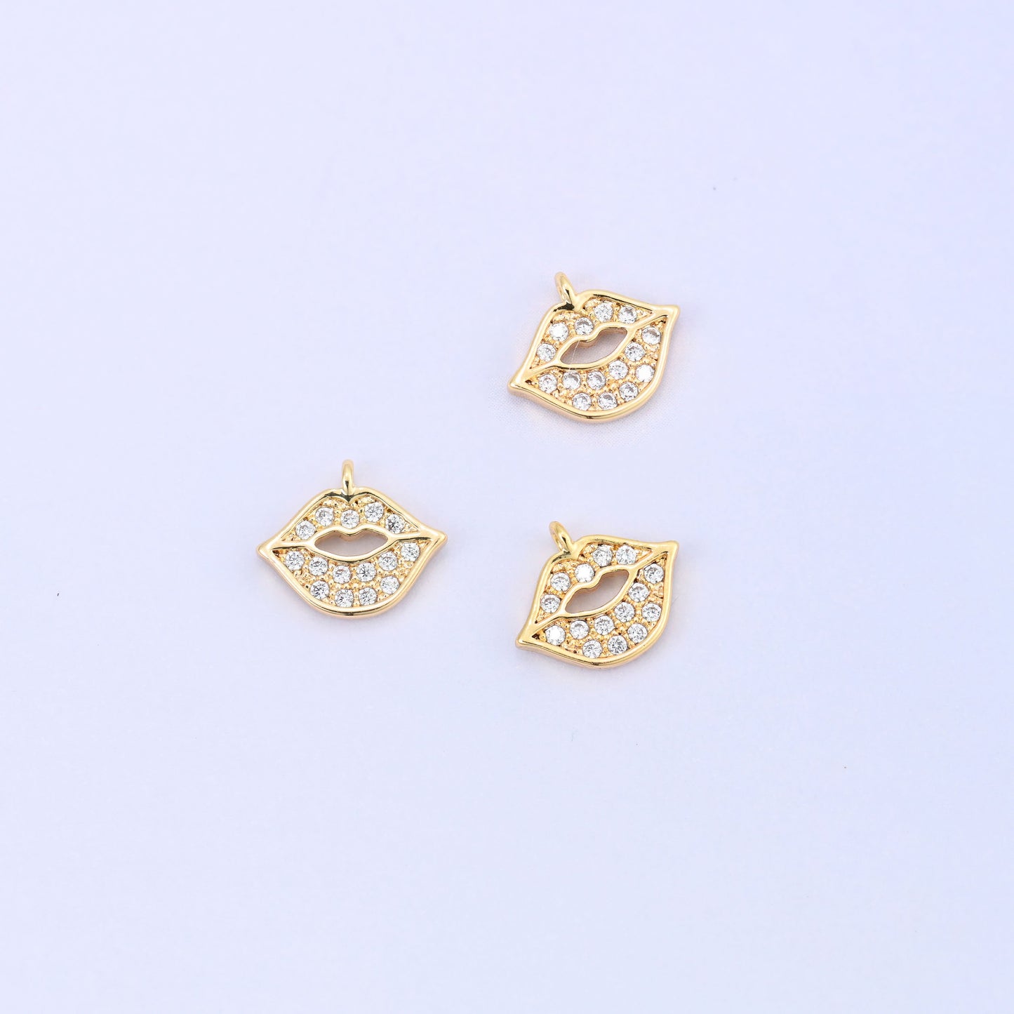 Small gold charms, three lip charms with clear cubic zirconia facing forward