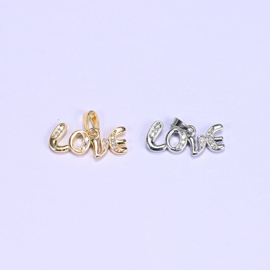 Love letter zirconia charm colour comparison: one 18K gold plated Love script pendant beside the same design in platinum-tone silver.