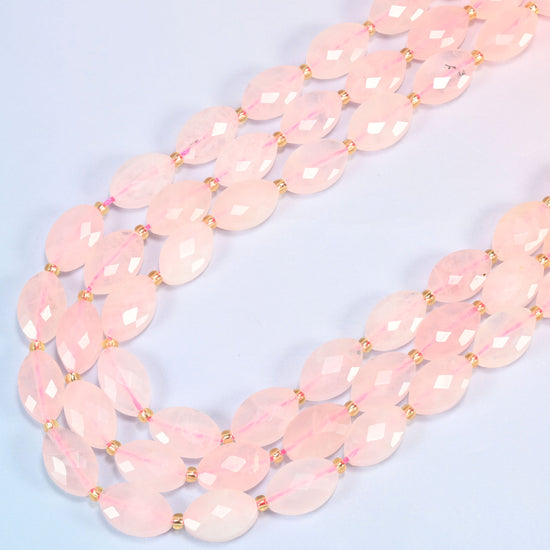 Rose quartz faceted flat oval beads in several strands curved into a wide U, soft blush pink stone
