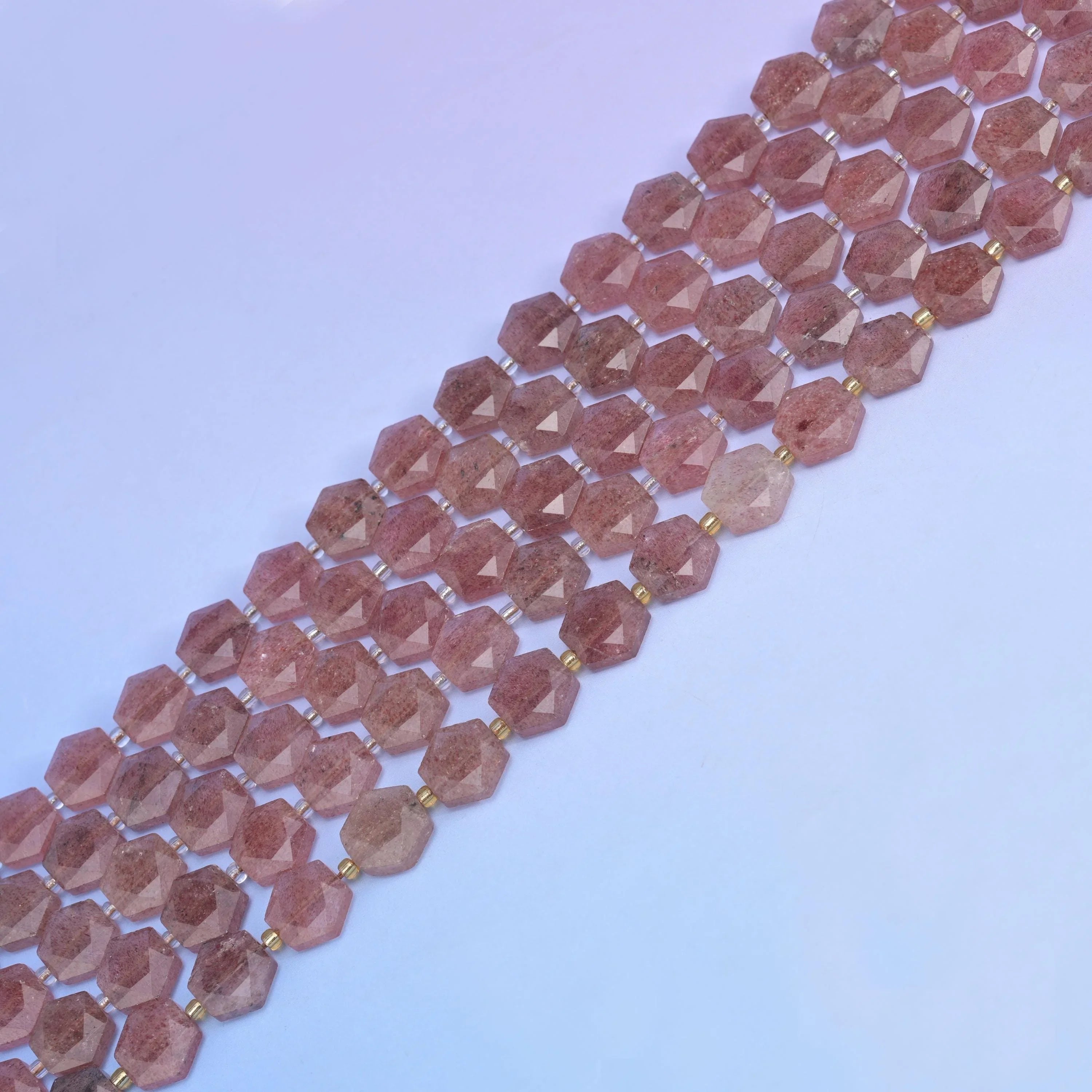 Strawberry Quartz in dusky rose-brown with fine dark inclusions.