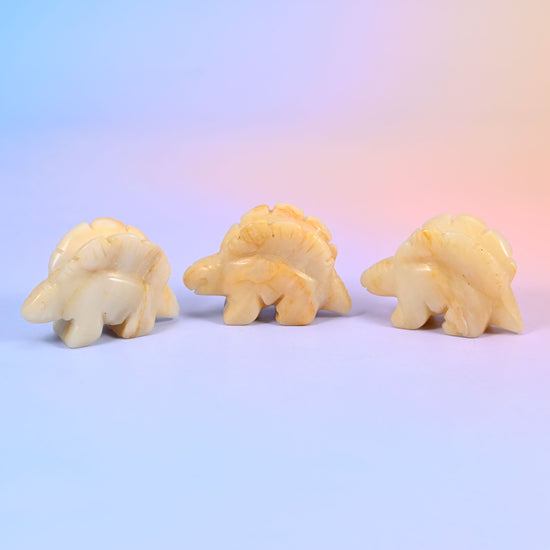 Stegosaurus dinosaur crystal carving, about 2 inches, with a ridged row of plates along its back