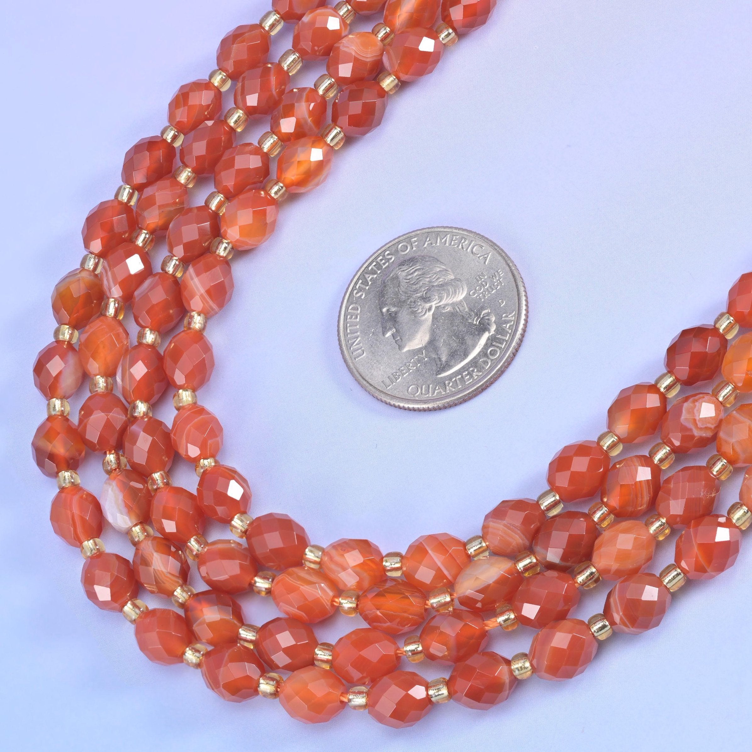 Dyed Red Stripe Agate Faceted Rice Barrel Beads in warm orange-red with cream banding
