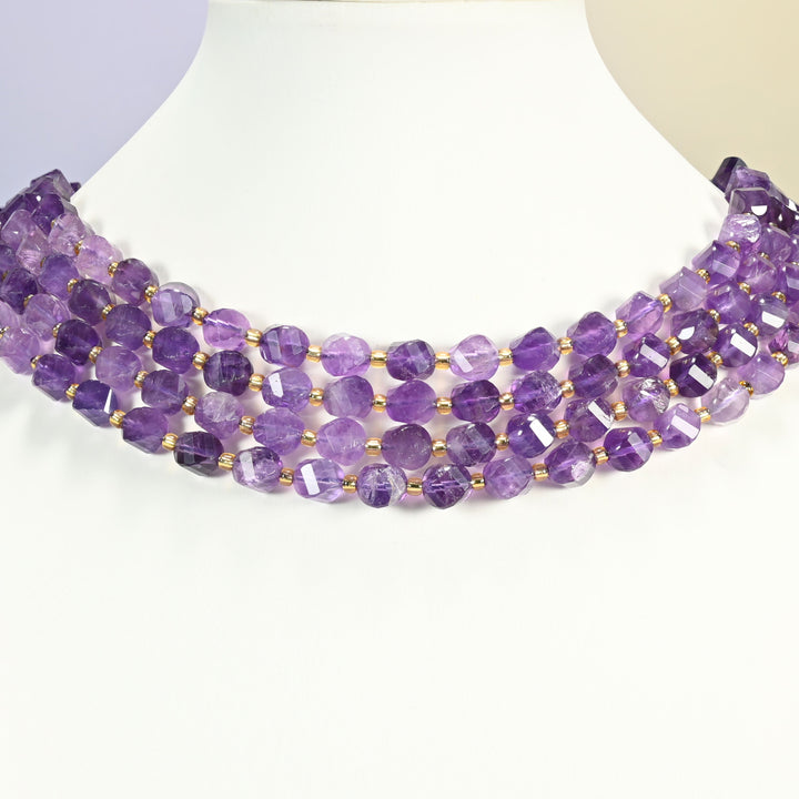 Amethyst faceted spiral twist beads on a white neck display, three strands lying flat around the bust.