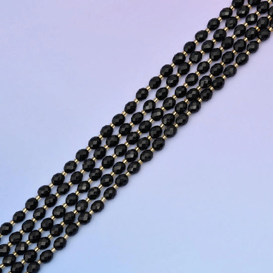 Black Onyx Faceted Rice Barrel Beads, approximately 39 beads per strand.