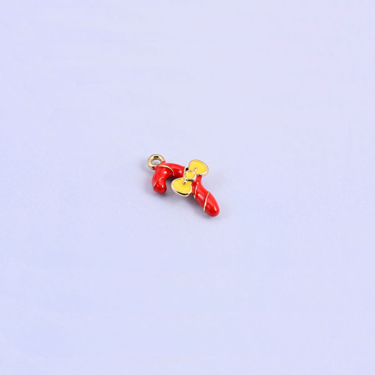 Single candy cane charm angled to show the small gold ring at the top for easy attaching.
