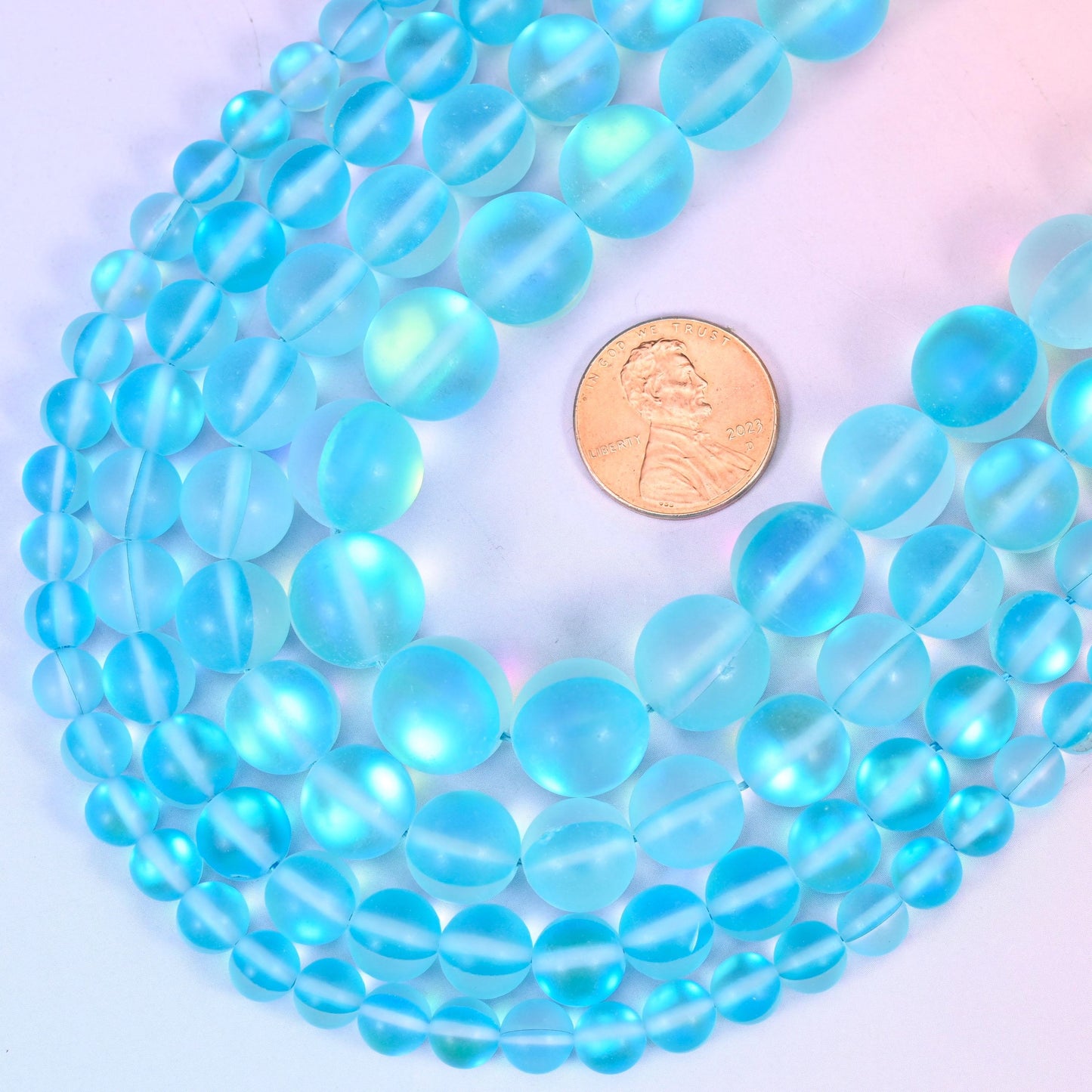 Round matte frosted light blue glass beads with iridescent coating