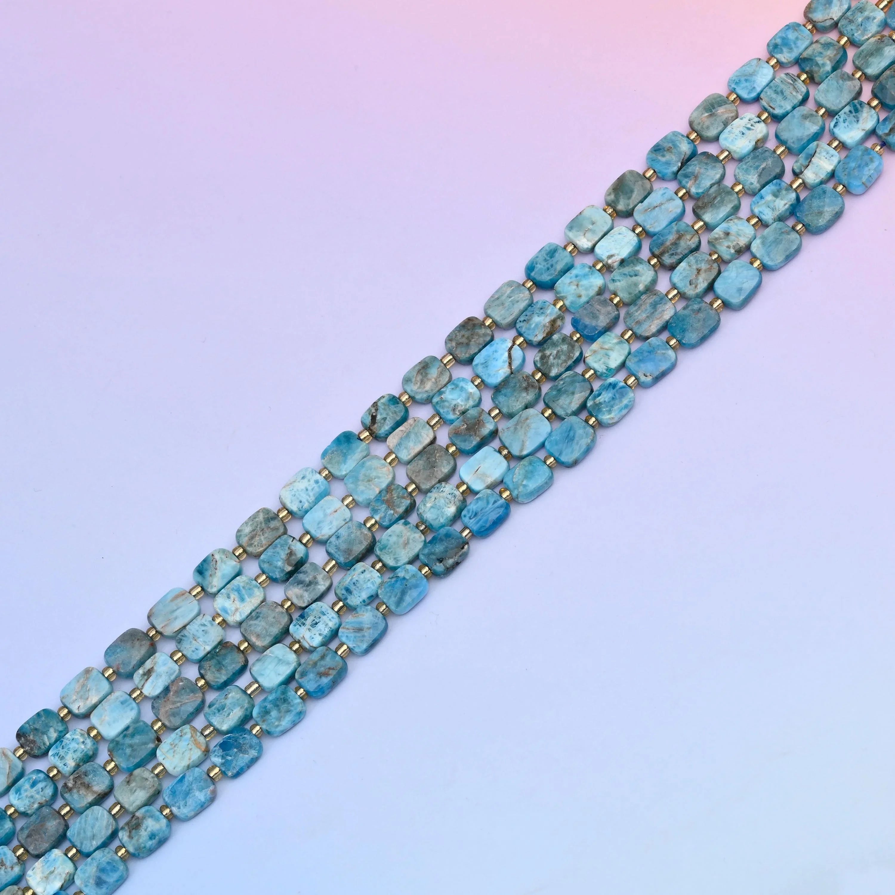 Blue apatite beads in sea-blue and teal tones with grey-brown matrix