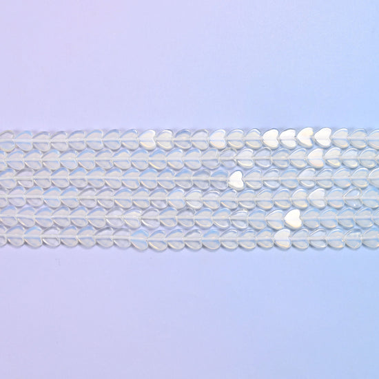 Opalite Flat Heart Beads in milky white with a blue opalescent glow