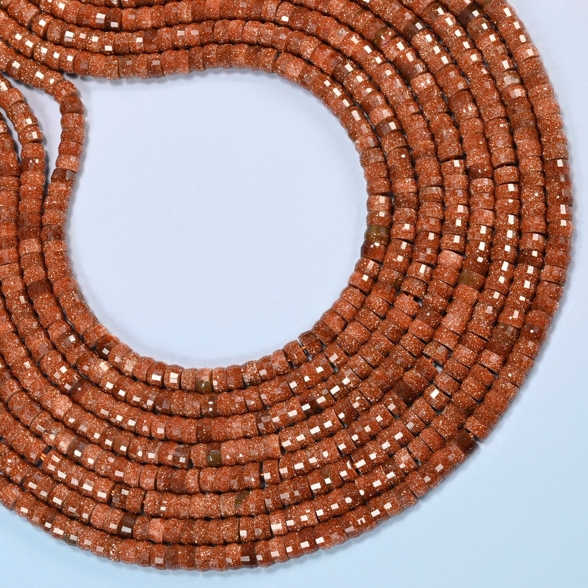 Gold sandstone faceted heishi disc beads curved into an open loop, copper brown beads with gold glitter