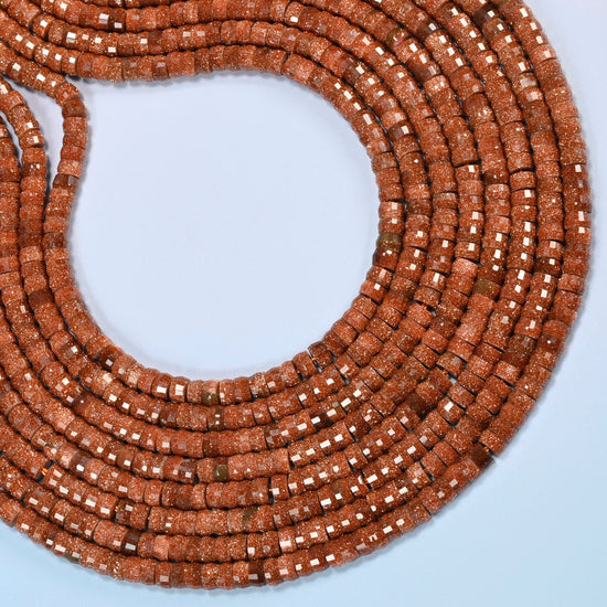 Gold sandstone faceted heishi disc beads curved into an open loop, copper brown beads with gold glitter