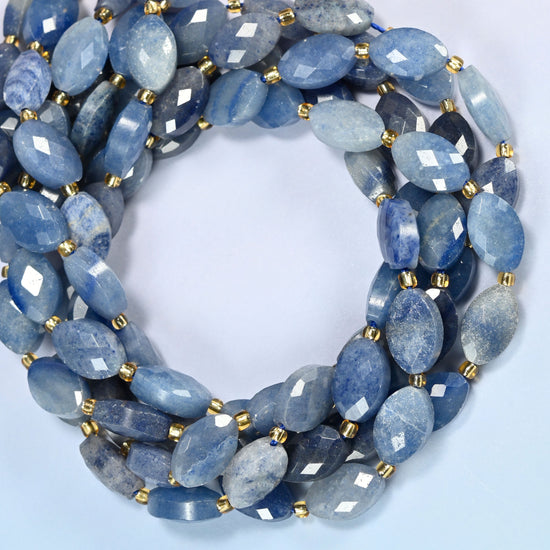 Blue aventurine faceted flat oval beads coiled into overlapping loops, whole strands of cool blue stone