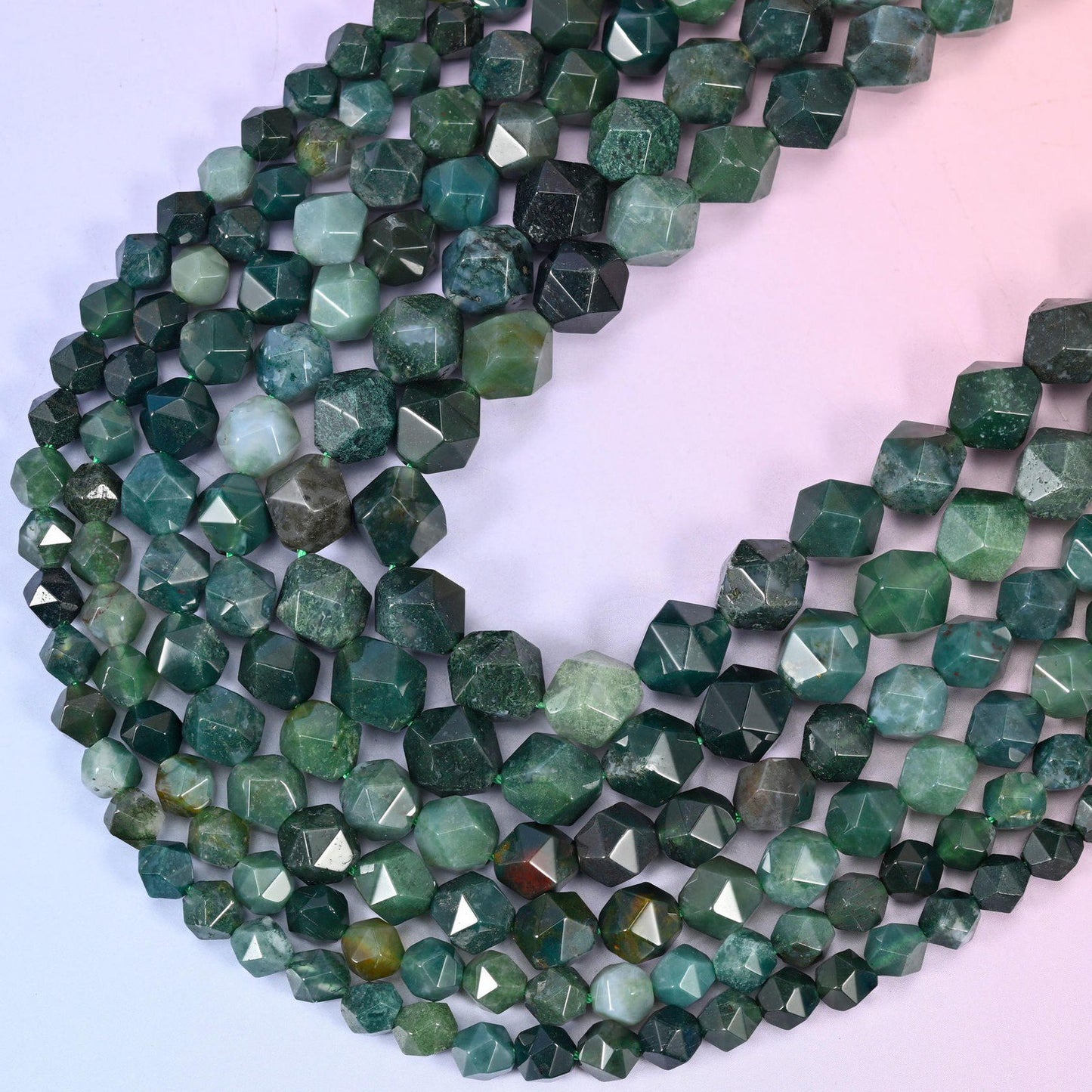 Moss Agate diamond star cut beads, strands crossing in a V, natural stone with the density of green markings varying bead to bead
