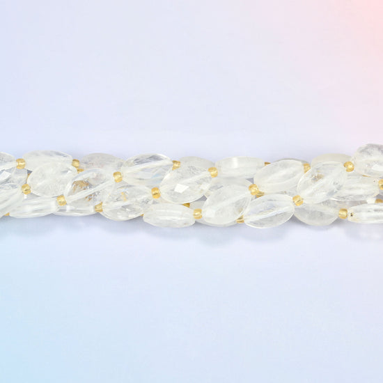 Strands of clear quartz faceted flat oval beads twisted together in a horizontal row