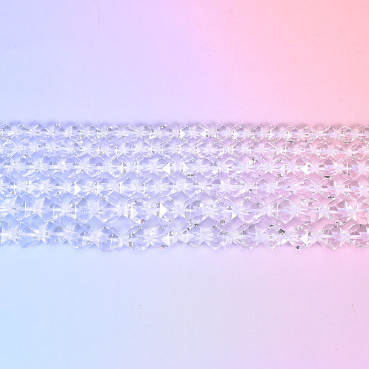 Clear Quartz diamond star cut beads laid in rows, faceted rounds in 6mm, 8mm and 10mm