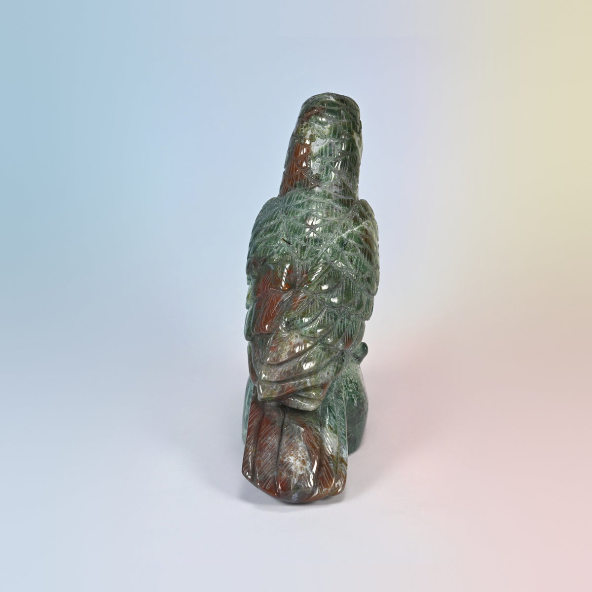 Back view of the Indian agate crow carving showing carved tail feathers in green and brick red