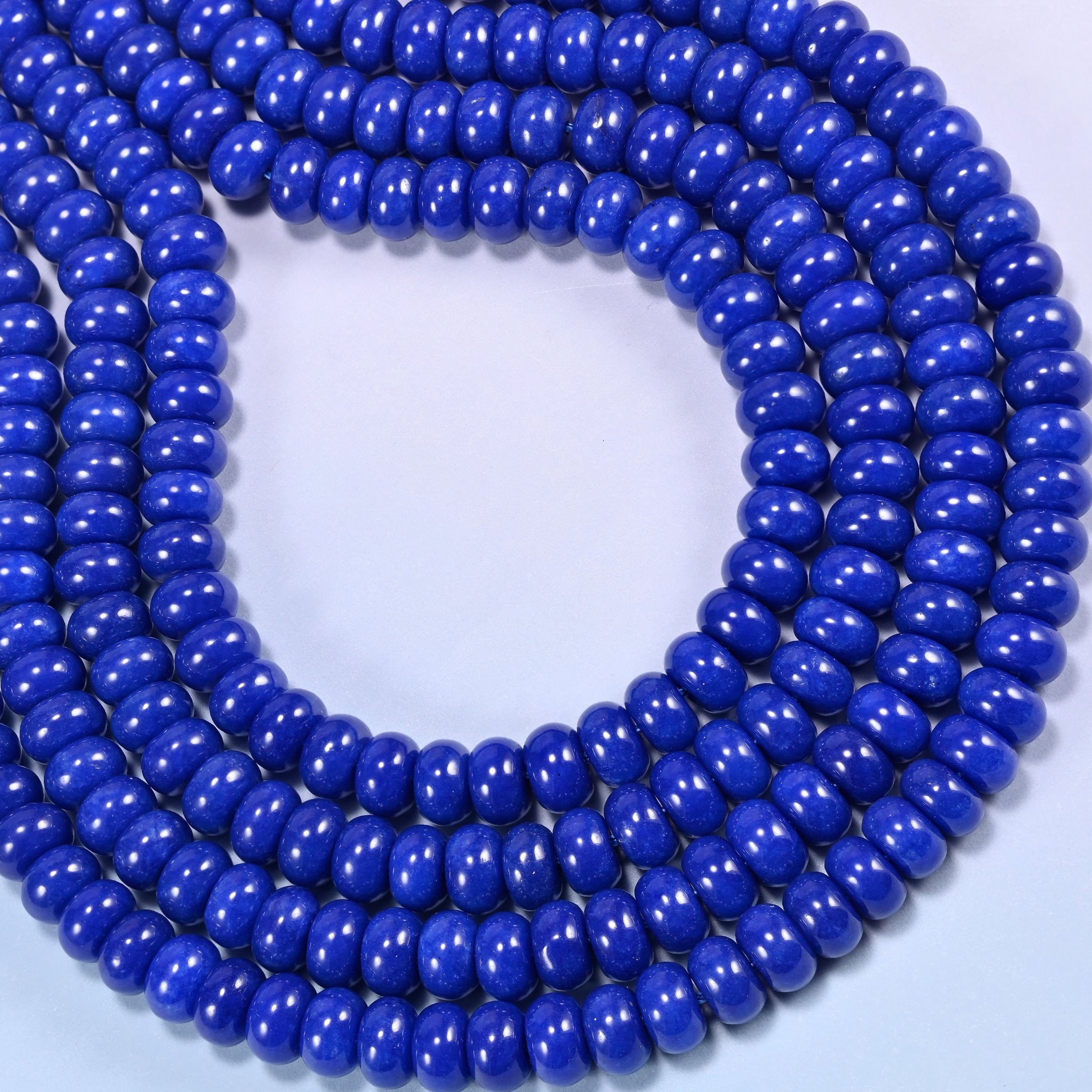 Dark Blue dyed jade gemstone rondelle beads coiled into a rounded loop, a 15 inch strand holding about 75 beads