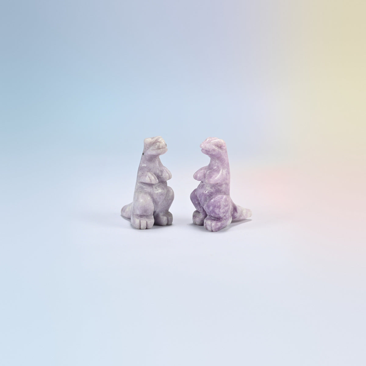 Two lepidolite T-Rex dinosaur crystal carvings, 2 inch, lilac natural stone with purple flecks