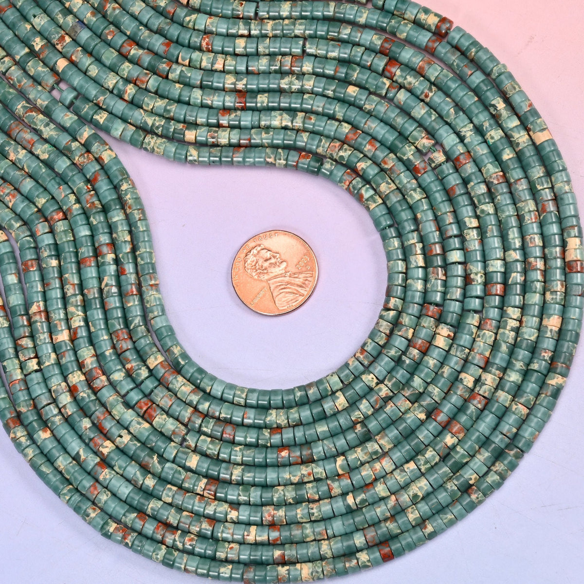 Teal green mottled with rust red and cream, cut into fine discs and polished flat — the Sea Sediment Jasper look, carrying the pattern of a much larger cabochon at only 4mm across.
