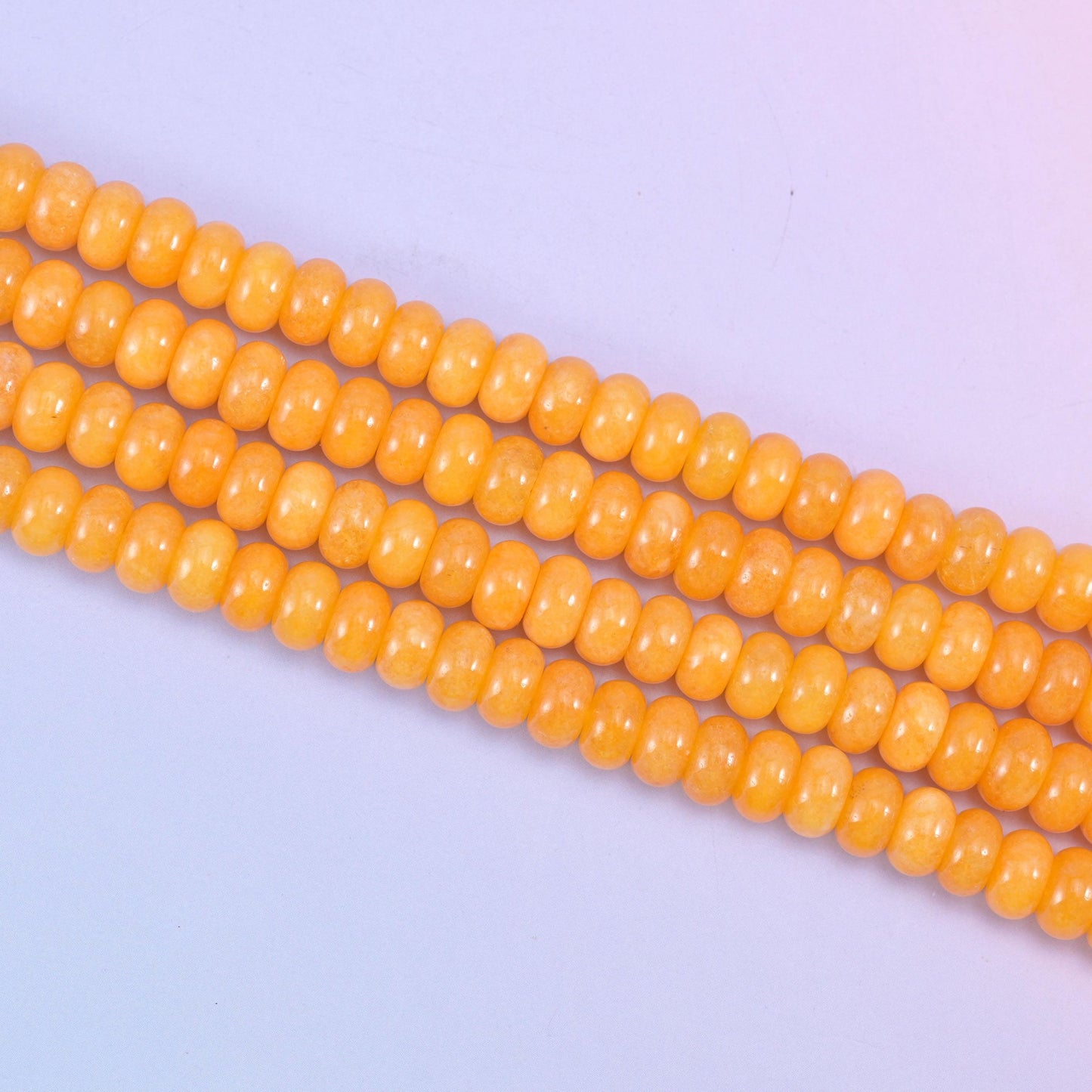 Orange Dyed Jade beads in a warm golden-orange tone