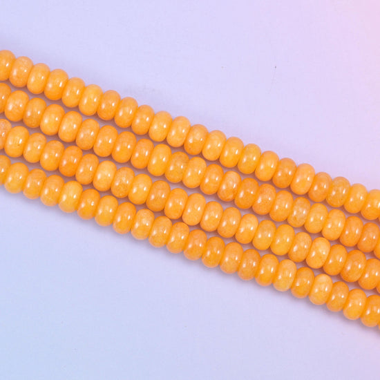 Orange Dyed Jade beads in a warm golden-orange tone