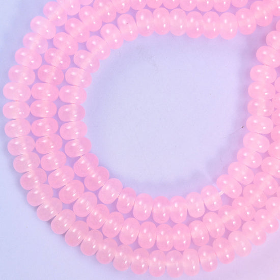 Pink Dyed Jade smooth rondelle beads in a soft blush pink, finished with a smooth, polished surface for a classic, timeless look.