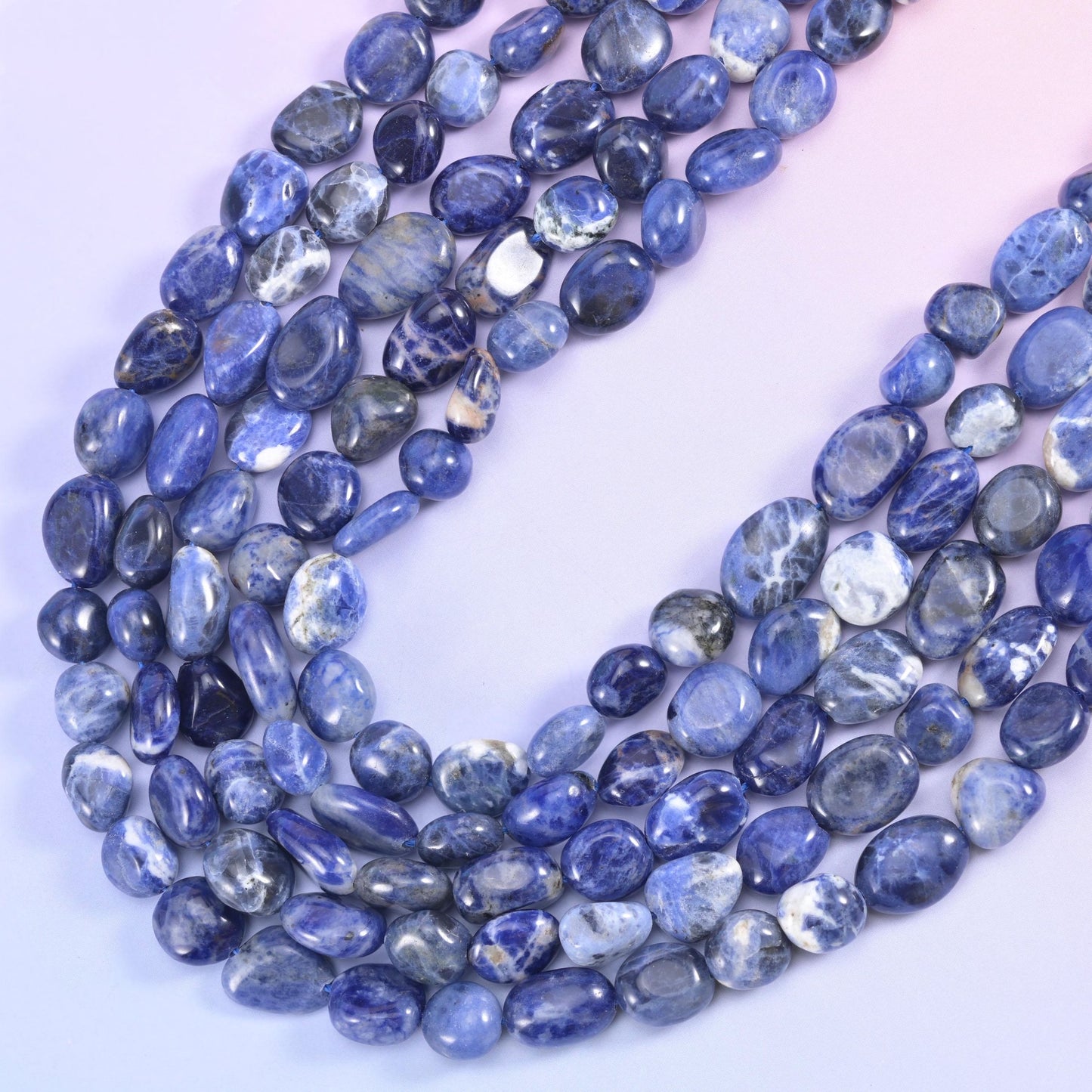 Sodalite nugget strands falling in a soft drape, denim blue shot through with white