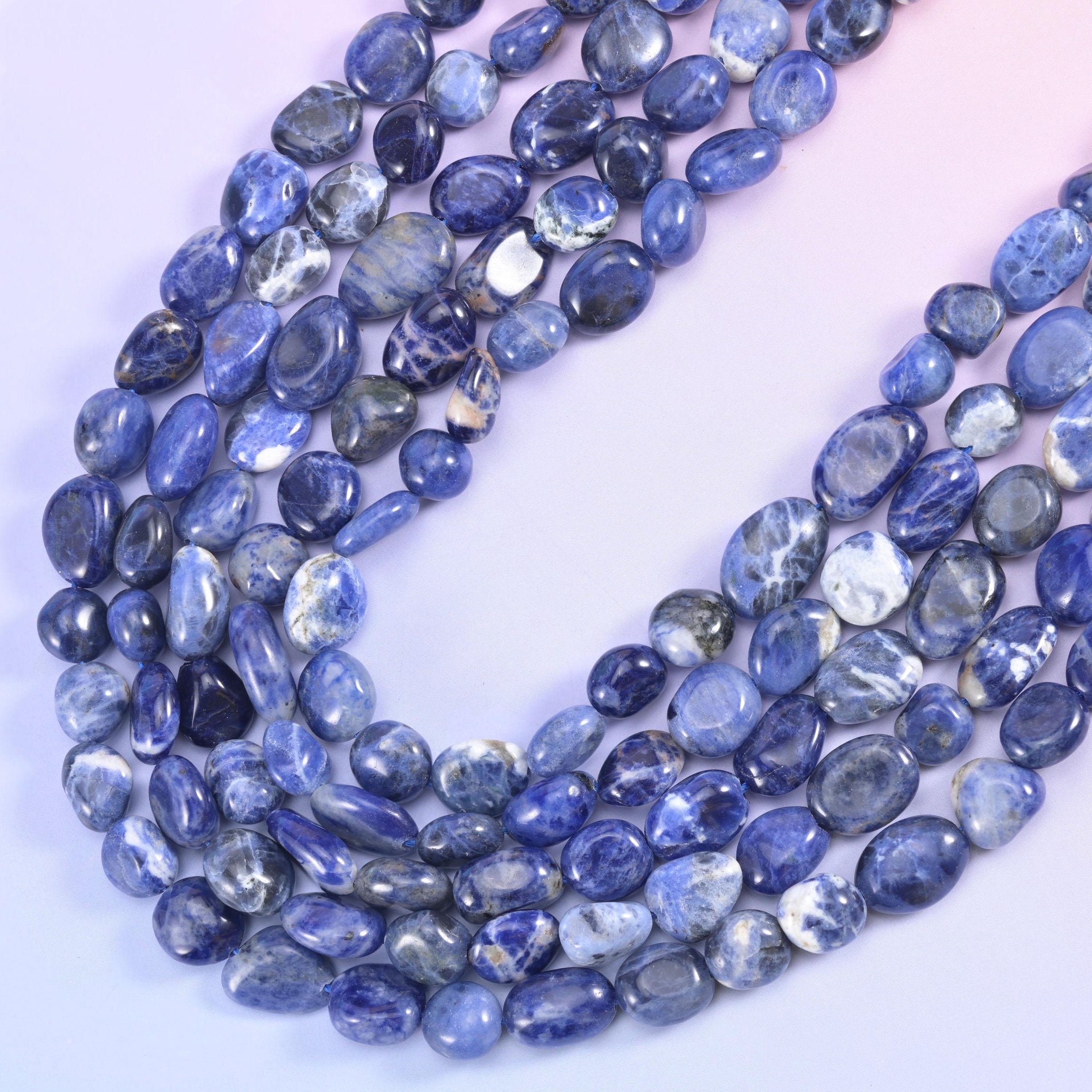 Sodalite nugget strands falling in a soft drape, denim blue shot through with white