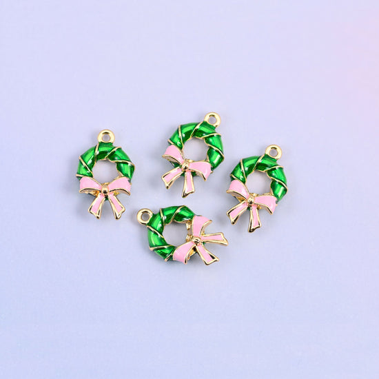 Four green wreath charms with light pink bows grouped together, enamel over 18K gold plated brass.