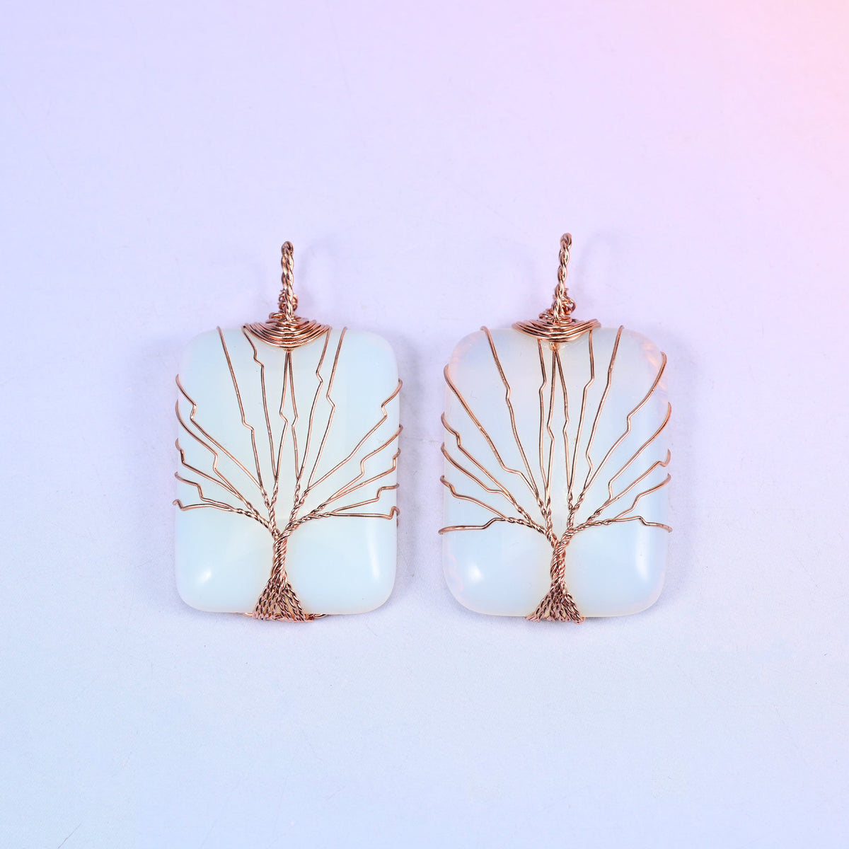 Rectangle Gemstone Tree of Life Pendant in milky white stone, two pieces side by side, the copper branches spread wide across the light surface.