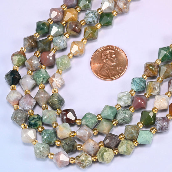 Indian Agate faceted bicone beads 8mm with gold-tone spacers, strand coiled into a loose loop with a penny alongside for scale
