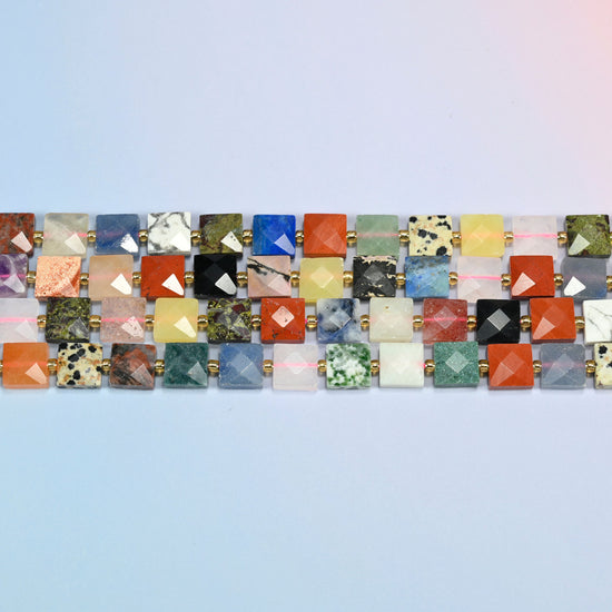 Several strands of assorted gemstone faceted flat square beads laid in straight rows